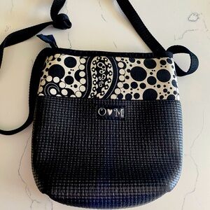 Over the shoulder bag. Black with funky material band.  Excellent condition.